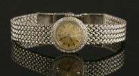 Lot 304 - A ladies' 18ct white gold diamond set Omega 'Ladymatic' mechanical bracelet watch