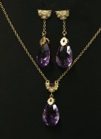 Lot 278 - An amethyst and diamond matching gold pendant and earring suite