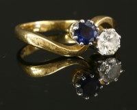 Lot 402 - An 18ct gold two stone sapphire and diamond crossover ring
