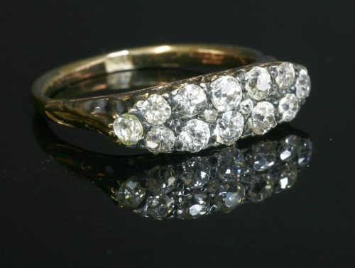 Lot 60 - An Edwardian two row diamond boat shaped carved head ring