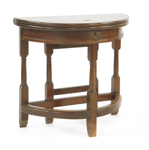 Lot 524 - A George II-style mahogany fold-over demilune side table