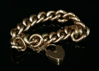 Lot 11 - A 9ct gold hollow textured and polished curb link bracelet with padlock