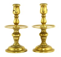 Lot 910 - A pair of Heemskerk-type brass candlesticks