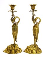 Lot 785 - A rare pair of gilt and silvered bronze candlesticks