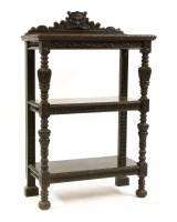 Lot 630 - A carved oak three tier buffet