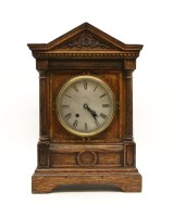 Lot 418 - A late 19th century oak mantel clock
