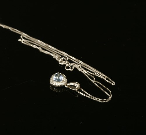 Lot 1 - A white gold aquamarine and diamond cluster pendant