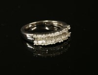 Lot 27 - A white gold three row diamond ring with a tapering plain polished shank