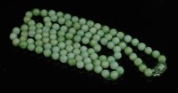 Lot 131 - A single row uniform jade bead necklace