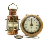 Lot 334 - A copper and brass ships lantern and a postman’s clock