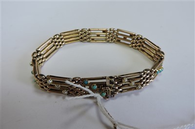 Lot 65 - An Edwardian four row gold gate bracelet