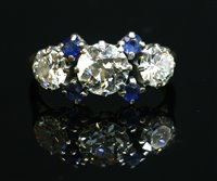 Lot 324 - An 18ct gold diamond and sapphire ring
