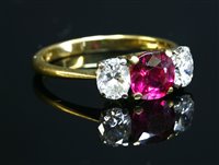 Lot 513 - An 18ct gold three stone ruby and diamond ring by Kutchinsky
