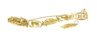 Lot 35 - An Egyptian gold pierced panel bracelet and matching pendant
