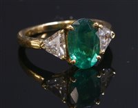 Lot 352 - A French three stone emerald and diamond gold ring