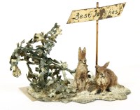 Lot 163 - An Austrian novelty cold painted aluminium group of two rabbits in a snowy landscape
