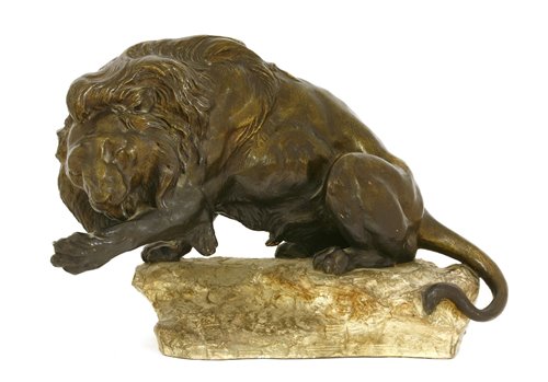 Lot 240 - A lion cleaning his paw