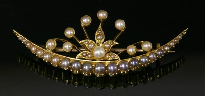 Lot 89 - A late Victorian gold seed pearl and split pearl crescent brooch