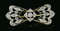 Lot 154 - A French Belle Époque diamond set bow form brooch, c.1915