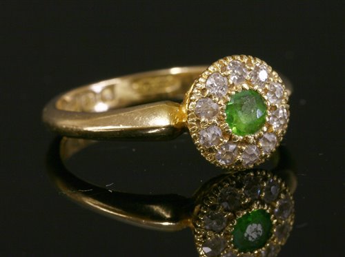 Lot 95 - An 18ct gold Edwardian peridot and diamond circular cluster ring