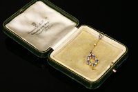Lot 101 - An Edwardian gold sapphire and split pearl Edna May style pendant, c.1910