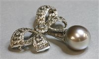Lot 334 - A white gold Tahitian cultured pearl and diamond bow brooch