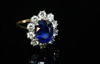 Lot 542 - An 18ct gold sapphire and diamond oval cluster ring