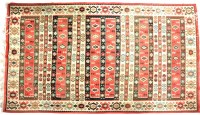 Lot 689 - A Kilim rug with stylised geometric designs on a white ground within a red border