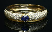 Lot 268 - A gold, sapphire and diamond hinged bangle
