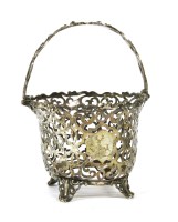 Lot 211 - A Victorian pierced swing handled sugar basket