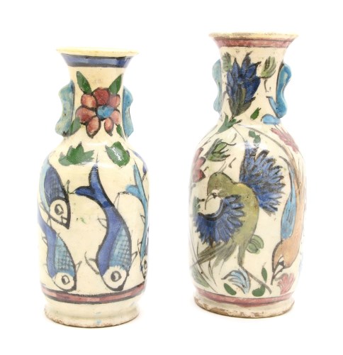 Lot 251 - A near pair of Persian hand painted twin handled pottery vases