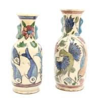 Lot 251 - A near pair of Persian hand painted twin handled pottery vases
