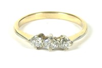 Lot 60 - A gold three stone diamond ring claw set to tapering shoulders and a plain polished shank 2.18g size N