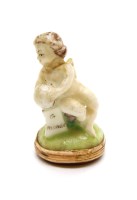 Lot 237 - A porcelain seal fob in the shape of a cherub