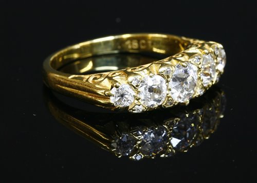 Lot 61 - A five stone graduated diamond carved head style ring