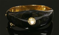 Lot 68 - A Victorian gold, pearl, diamond and enamel memorial hinged bangle