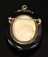 Lot 69 - A Victorian gold oval onyx glazed pendant/brooch picture locket
