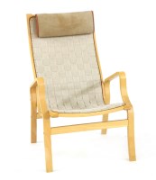 Lot 704 - A laminated beech armchair