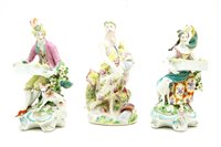 Lot 175 - A pair of Derby flower seller salts and a porcelain figure of Neptune. various losses
