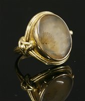 Lot 656 - A gold single stone moss agate ring