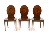 Lot 596A - A set of three George III mahogany hall chairs