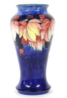 Lot 408 - A William Moorcroft `Leaf and Berry' pattern vase