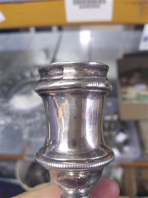 Lot 100 - A pair of George II silver candlesticks