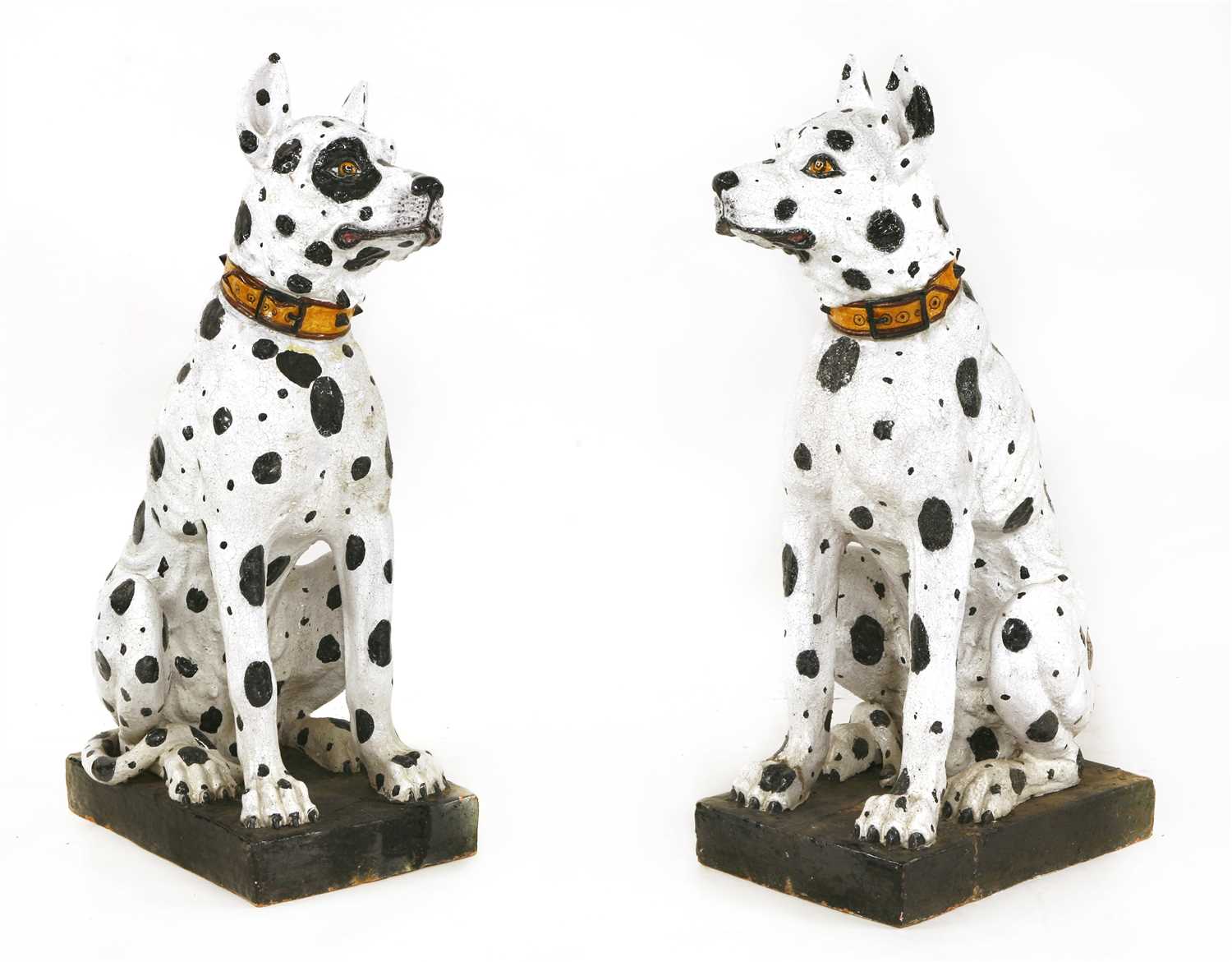 Lot 549 - A pair of life-sized Continental majolica pottery models of seated Great Danes