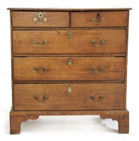 Lot 593 - A George III oak chest of drawers