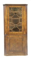 Lot 594 - An early 19th century burr yew wood corner cupboard