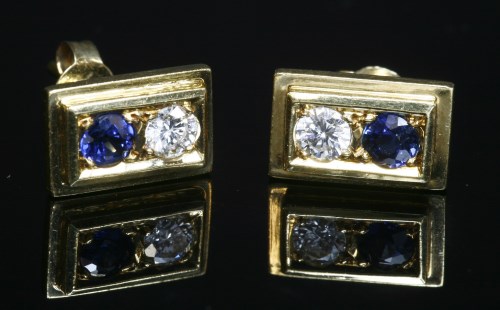 Lot 12 - A pair of gold two stone sapphire and diamond stud earrings
