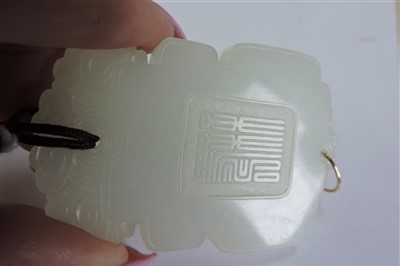 Lot 125 - A Chinese carved celadon nephrite Pei
