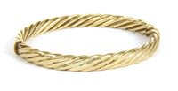 Lot 30 - A gold twisted rope hinge bangle