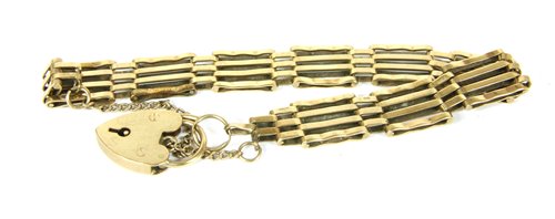 Lot 15 - A 9ct gold four row gate link bracelet with padlock